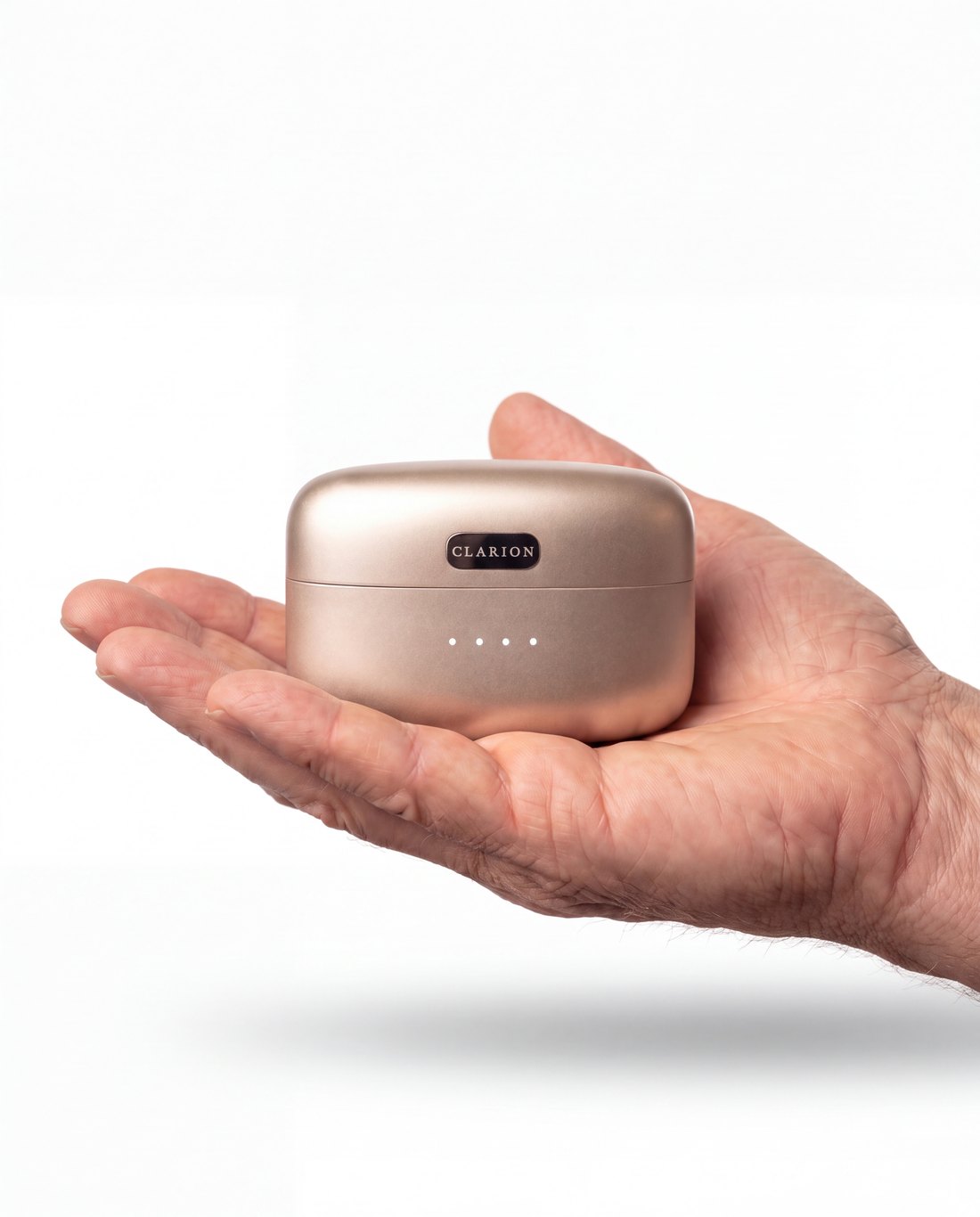 The closed Clarion charging case resting in an open palm, to show how small it is.