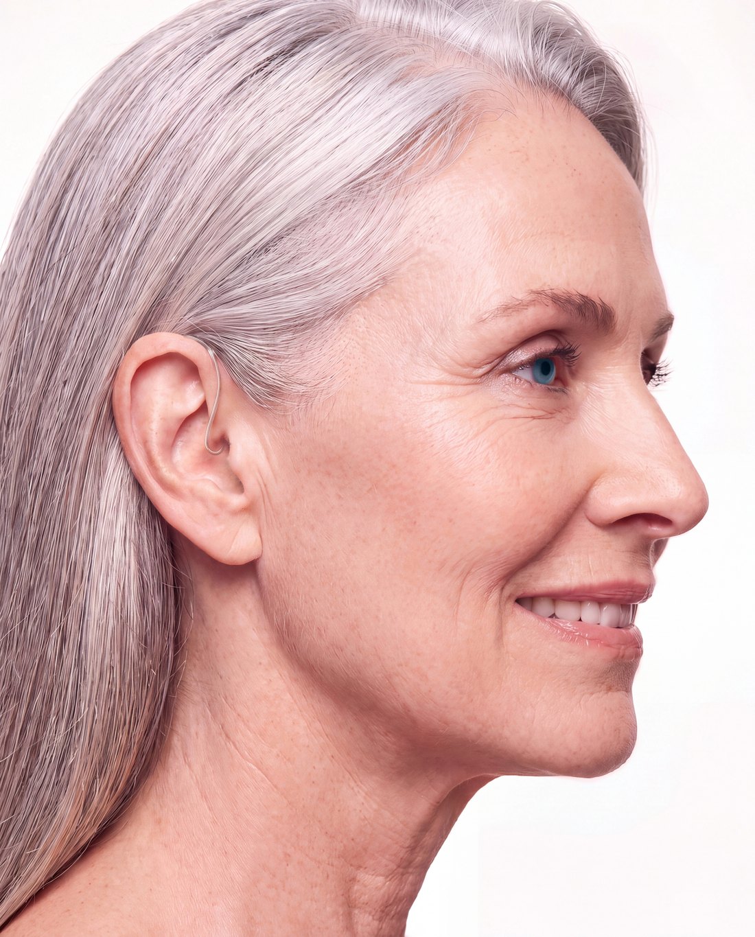 A woman in profile wearing a Clarion hearing aid: only a hair-thin clear wire into the ear shows.